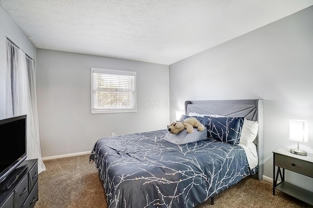 bedroom with carpet flooring, a textured ceiling, and baseboards