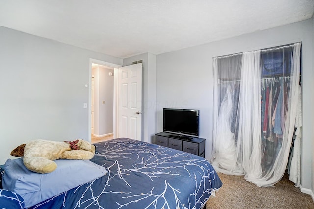 carpeted bedroom with baseboards