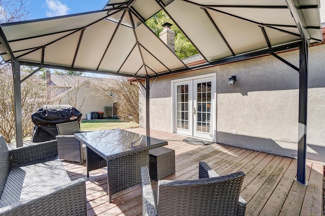 deck featuring a gazebo, area for grilling, and french doors