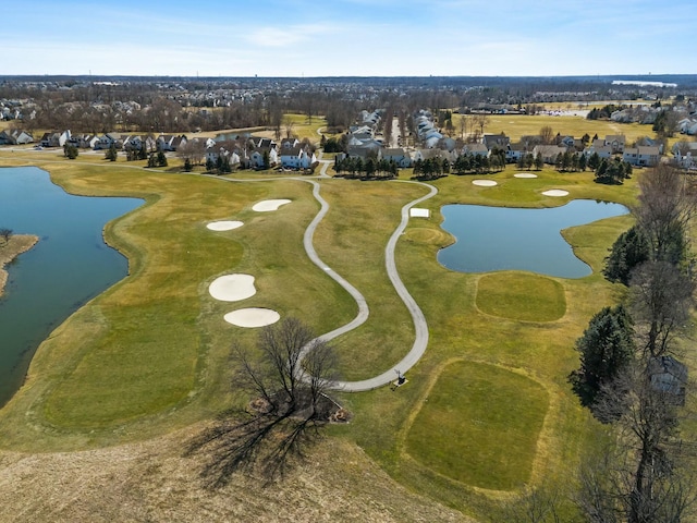 aerial view with a residential view, golf course view, and a water view