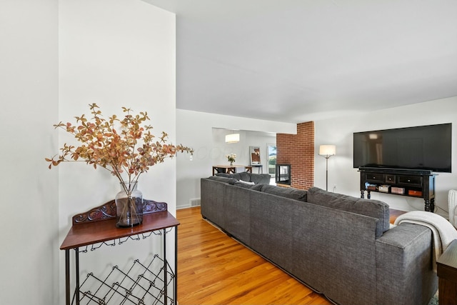 living room with visible vents and light wood-style flooring