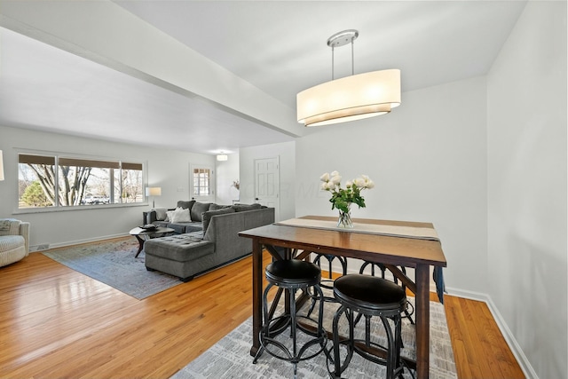 dining area featuring visible vents, baseboards, and light wood-style floors