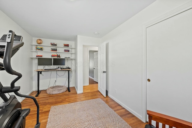 home office featuring wood finished floors and baseboards