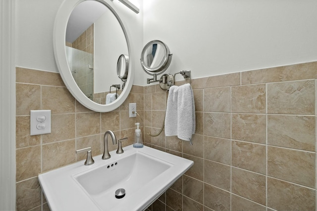 bathroom with tile walls and a sink