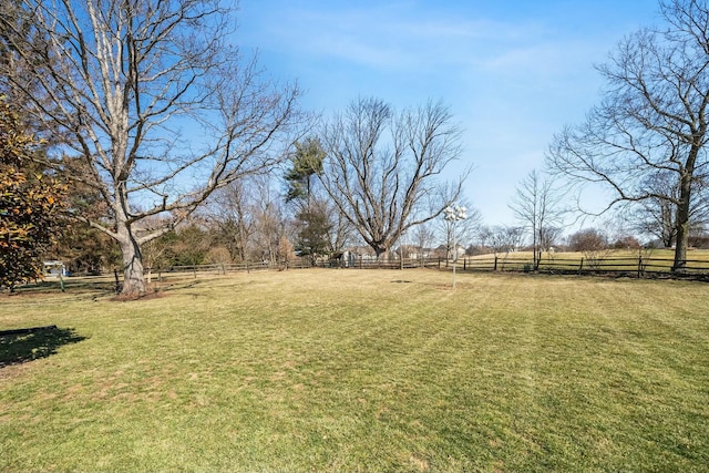 view of yard featuring a rural view and fence