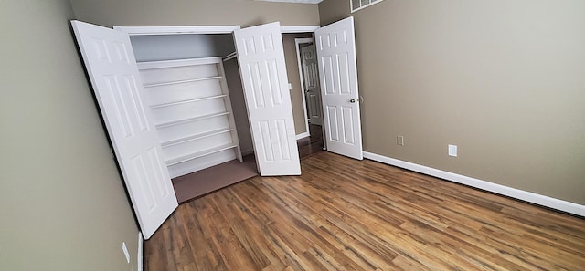 unfurnished bedroom featuring baseboards and wood finished floors