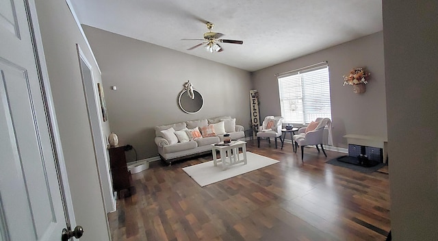 living room featuring ceiling fan, baseboards, dark wood-style floors, and vaulted ceiling