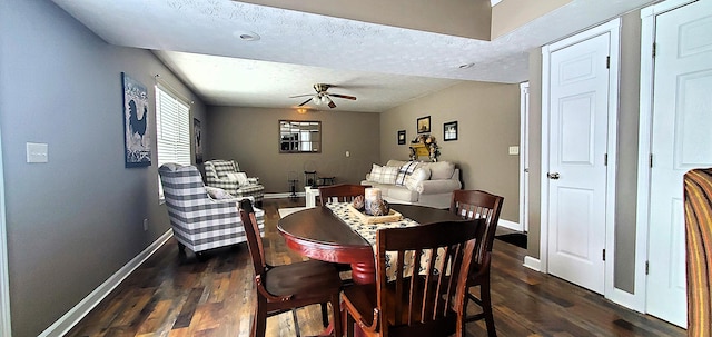 dining area featuring a ceiling fan, dark wood-style floors, baseboards, and a textured ceiling