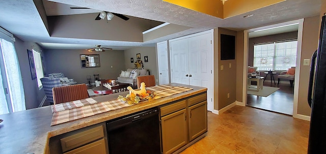 kitchen with a ceiling fan, baseboards, black appliances, a raised ceiling, and open floor plan