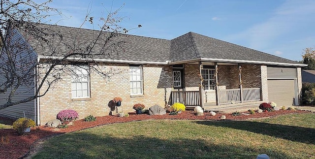 view of front of house featuring brick siding, covered porch, and a front yard