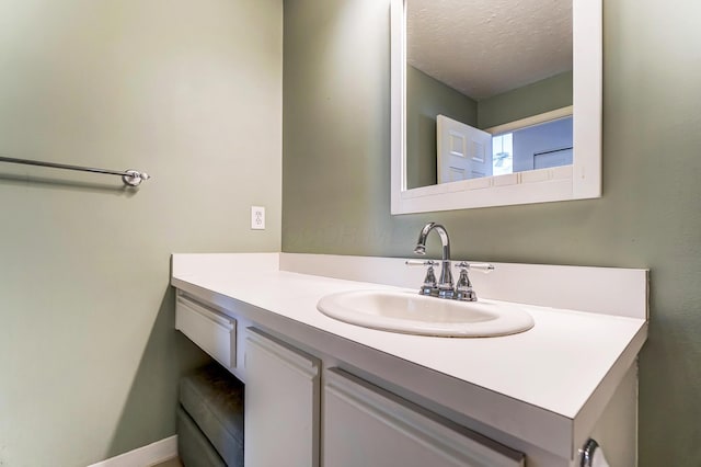 bathroom with a textured ceiling and vanity