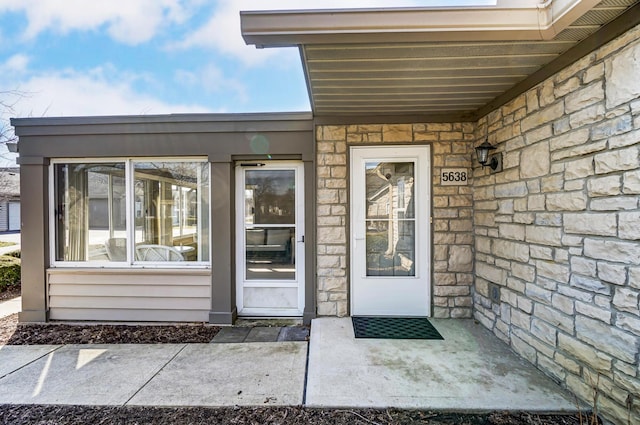 doorway to property featuring stone siding