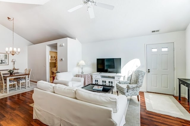 living area featuring ceiling fan with notable chandelier, vaulted ceiling, wood finished floors, and visible vents