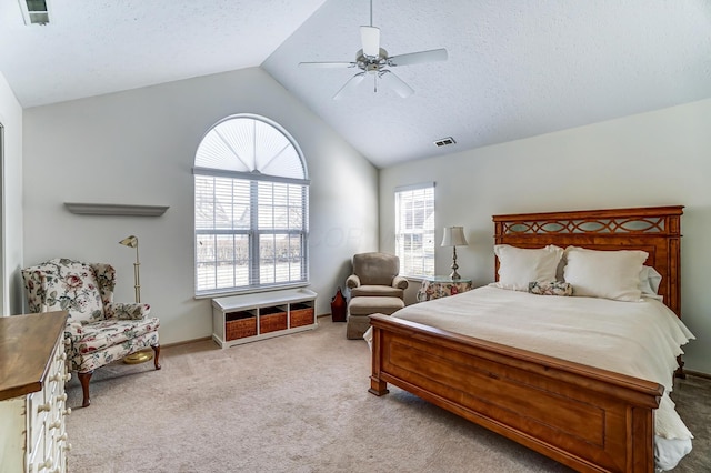 carpeted bedroom featuring lofted ceiling, a ceiling fan, visible vents, and a textured ceiling