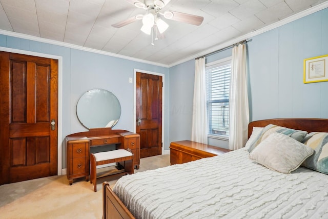 bedroom with light colored carpet, ceiling fan, and crown molding