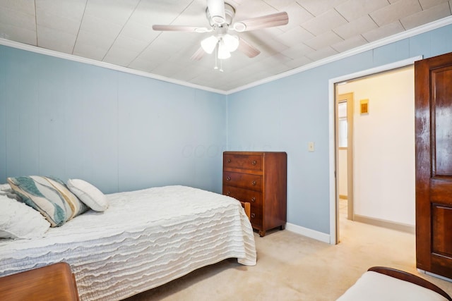 bedroom with crown molding, carpet flooring, a ceiling fan, and baseboards