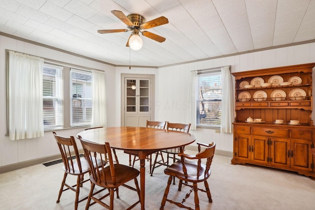 dining area with visible vents, a healthy amount of sunlight, crown molding, and a ceiling fan