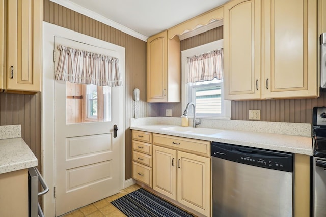 kitchen featuring a sink, stainless steel dishwasher, cream cabinetry, and crown molding