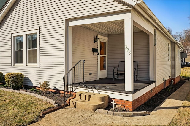 view of exterior entry with covered porch