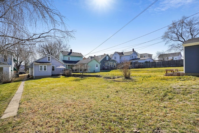 view of yard with a residential view and fence