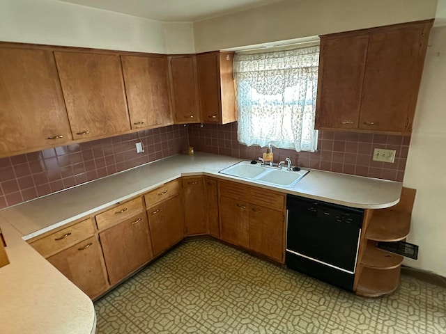 kitchen with light floors, dishwasher, light countertops, and a sink