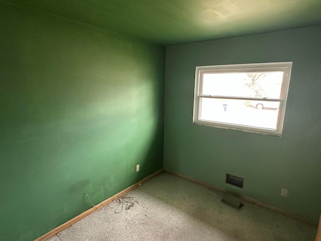 carpeted spare room with baseboards