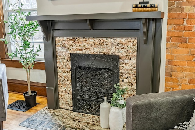 details featuring a fireplace and wood finished floors