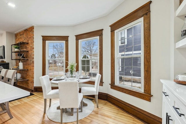 dining room with light wood-style flooring and baseboards