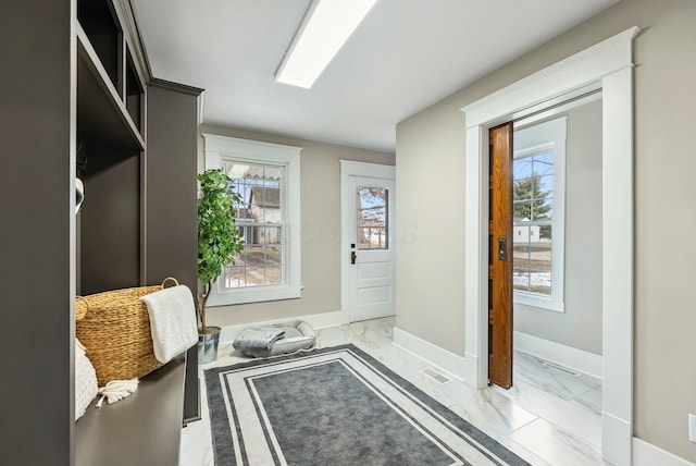 mudroom featuring visible vents, baseboards, marble finish floor, and a healthy amount of sunlight