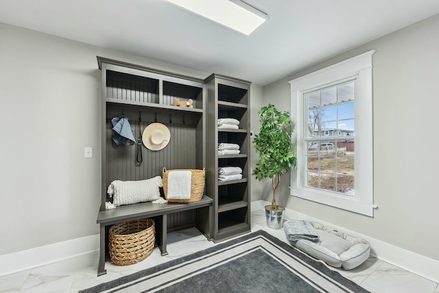 mudroom featuring baseboards and marble finish floor