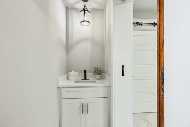 bathroom with a sink and marble finish floor