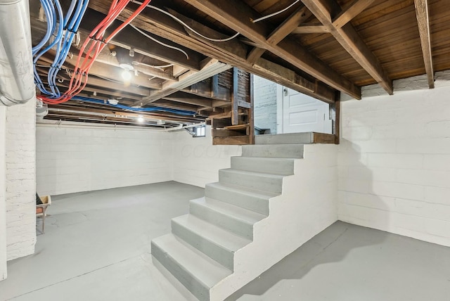 unfinished basement featuring stairway