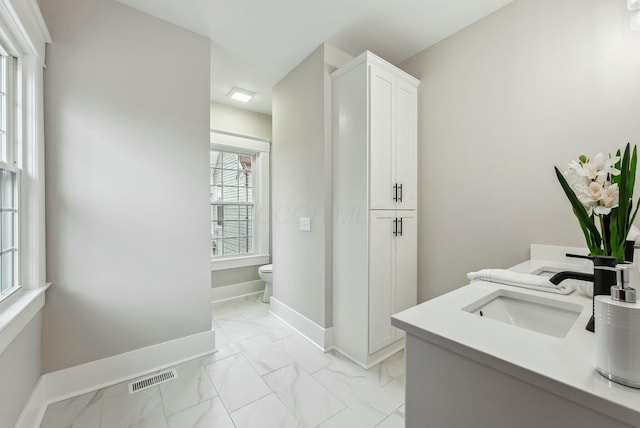 full bath featuring visible vents, toilet, marble finish floor, baseboards, and vanity