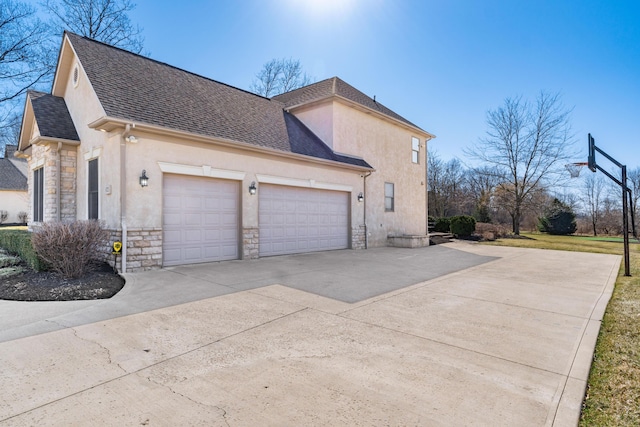 view of side of home featuring stucco siding, stone siding, concrete driveway, and a shingled roof