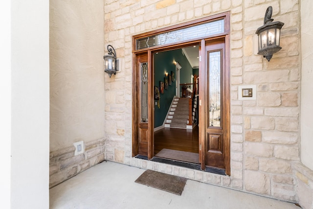 entrance to property featuring stone siding