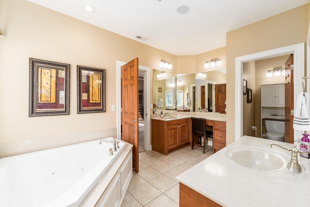 full bathroom featuring visible vents, a jetted tub, toilet, tile patterned floors, and vanity