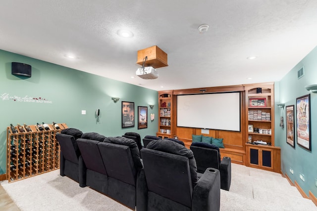 home theater with baseboards, built in features, carpet floors, recessed lighting, and a textured ceiling