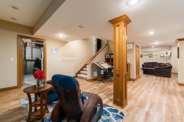 interior space featuring recessed lighting, baseboards, light wood-style floors, and stairs