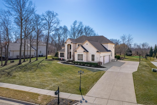 french provincial home featuring stone siding, a garage, driveway, and a front yard