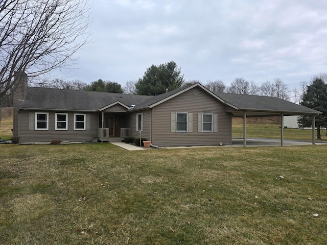 ranch-style home featuring an attached carport, a front lawn, and a shingled roof