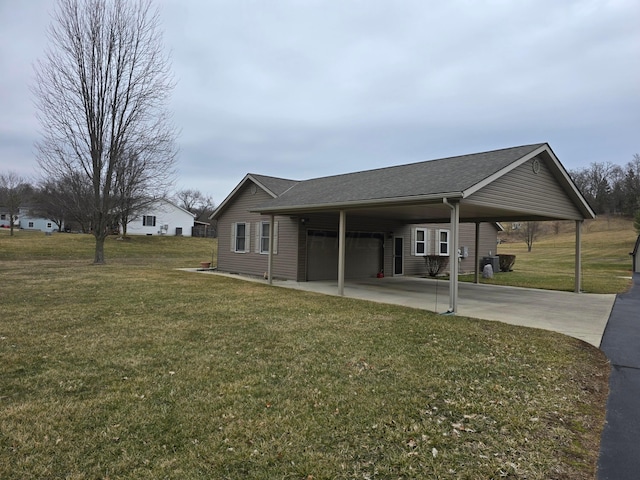 exterior space featuring an attached carport, driveway, a shingled roof, and a yard