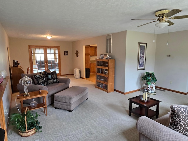 living room featuring baseboards, french doors, a textured ceiling, and carpet