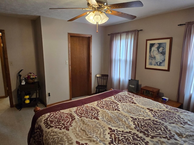 carpeted bedroom with baseboards and ceiling fan