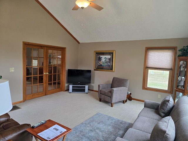 carpeted living area with french doors, baseboards, and ceiling fan