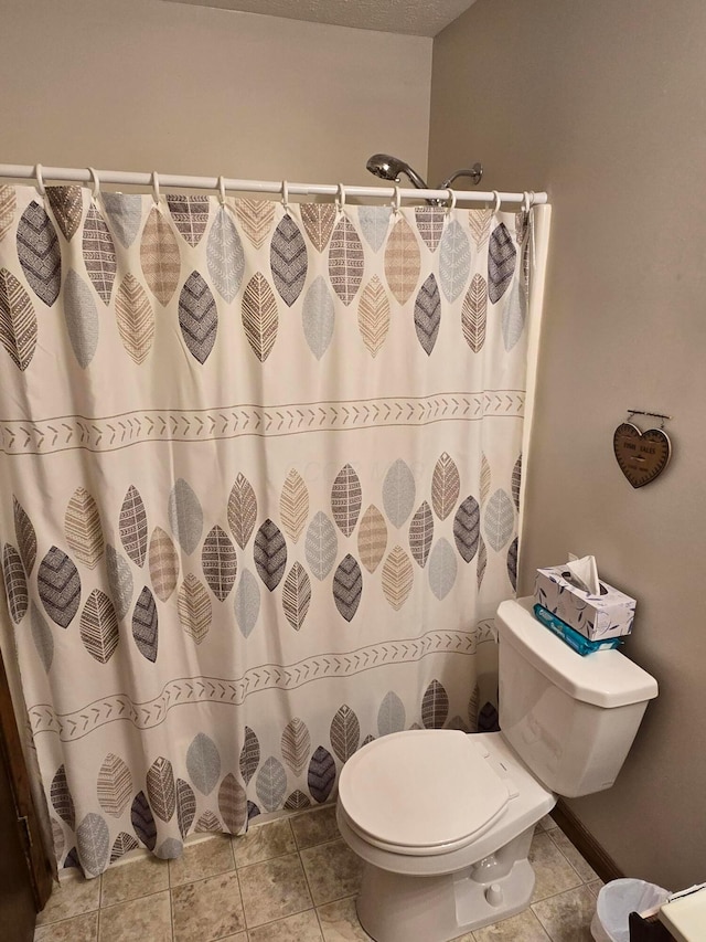 full bathroom with tile patterned floors, curtained shower, and toilet