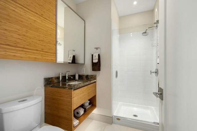 full bathroom featuring toilet, a stall shower, and vanity