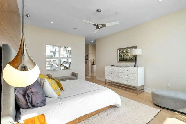 bedroom featuring visible vents, baseboards, wood finished floors, and a ceiling fan