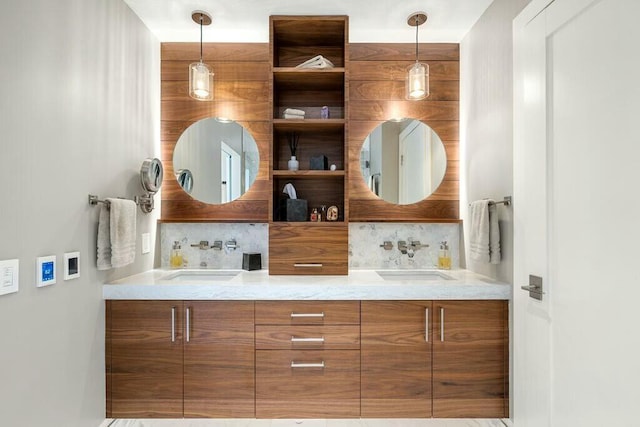 full bath featuring tasteful backsplash, double vanity, and a sink