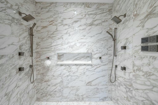 bathroom featuring a marble finish shower