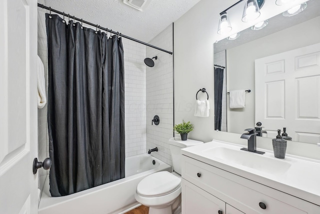 bathroom with visible vents, shower / bath combo with shower curtain, toilet, a textured ceiling, and vanity